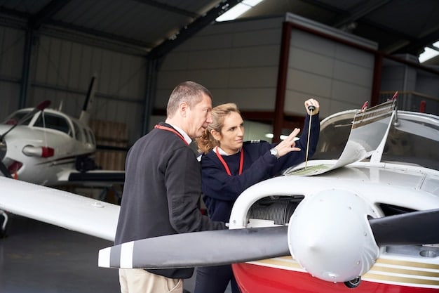 An instructor and a student pilot reviewing flight plans in a modern flight school facility, with several small training aircraft visible in the background.