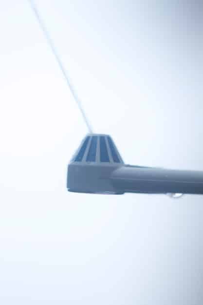 A detailed close-up of the wing of an Airbus A320neo during flight, showing the fuel-efficient wingtip devices. The background is a soft gradient of a sunrise sky.
