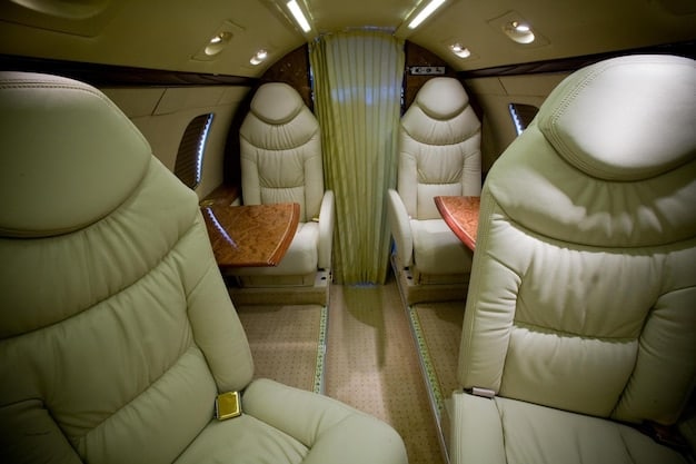 An interior shot of an Embraer E195-E2 regional jet, showcasing the updated cabin, spacious seating, and large overhead bins. The lighting is warm and inviting.