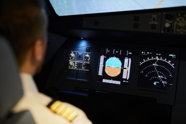 A close-up of a pilot's cockpit, showing the advanced avionics and digital displays that provide real-time data and navigational information.