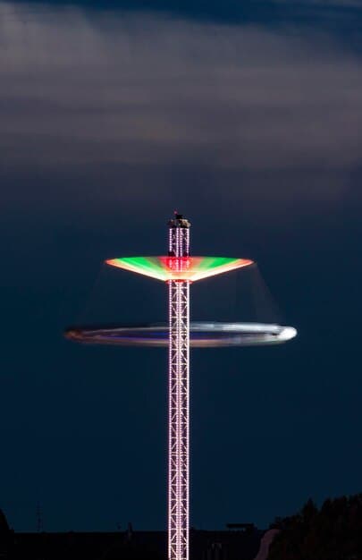 An image of an air traffic control tower at night, with illuminated screens showing flight paths and data, emphasizing the critical role of air traffic controllers in preventing near miss incidents.