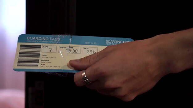 A close-up shot of an airline ticket displaying a high price and additional baggage fees, emphasizing the rising costs associated with air travel.