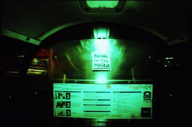 A close-up of a car's infotainment screen displaying a warning message about a potential cyberattack, highlighting the importance of security measures.