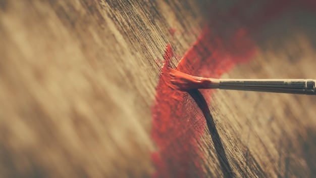 Close-up of a pinstriping artist meticulously applying a fine line of paint to a vintage car fender. The artist's hand is steady, holding a specialized pinstriping brush, with the paint flowing smoothly onto the surface. The lighting highlights the gloss of the paint and the precision of the line.