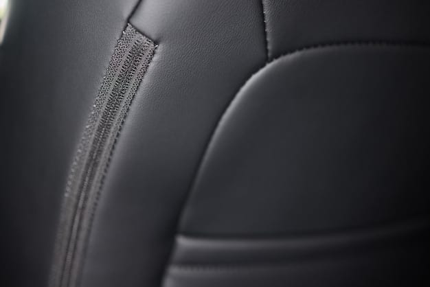 Close-up shot of a custom car's interior, showing intricate details like personalized stitching on the seats, a unique dashboard design, and custom lighting. The image highlights the level of craftsmanship and attention to detail that goes into car customization.