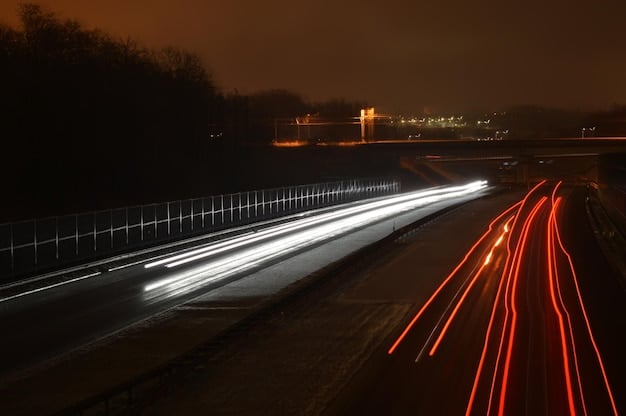 A long exposure shot of a car driving on a winding road at night, with light trails creating dynamic streaks and illuminating the car's sleek silhouette against the dark sky.