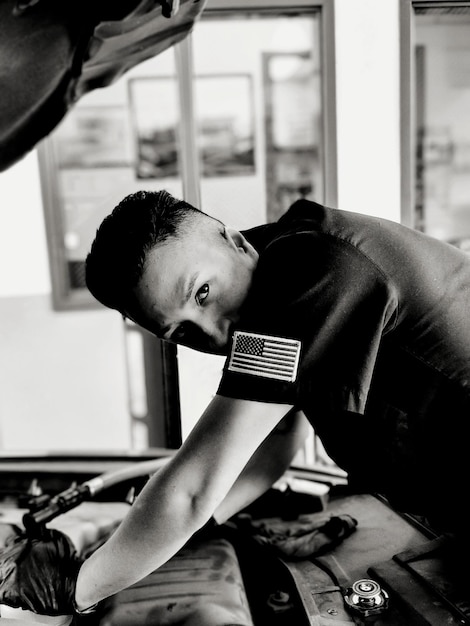 A close-up shot of an automotive influencer working on an engine in their garage. Tools are neatly arranged, and the influencer's focused expression conveys their expertise and passion for car mechanics.
