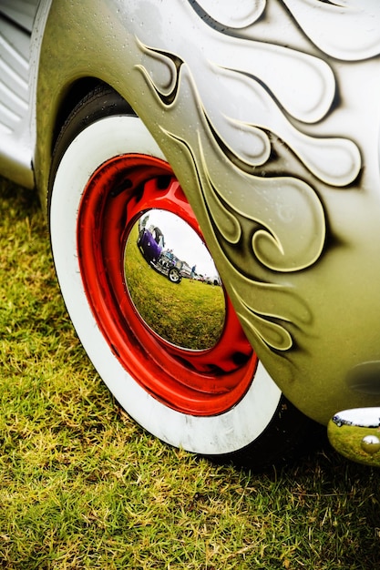 A split image showcasing a vintage Volkswagen Beetle next to a modern Volkswagen Beetle. The visual comparison highlights the design evolution while retaining iconic retro features like the rounded shape and headlights.