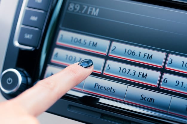 A car dashboard featuring a CD player with a digital display, showing track information and playback controls.
