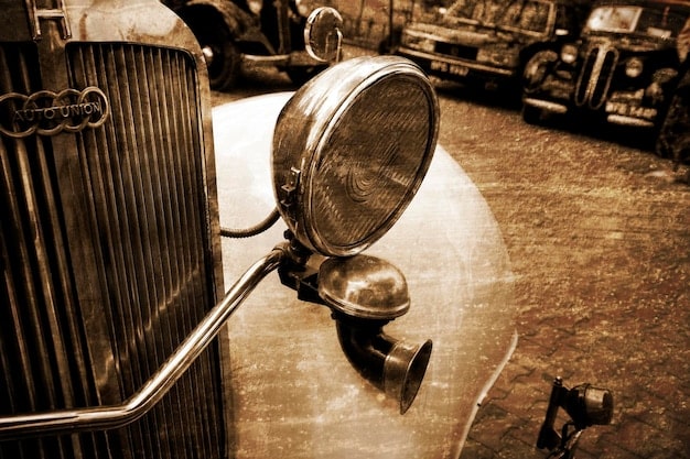A photograph of a classic car mechanic meticulously working on the engine of a vintage automobile, highlighting the importance of maintenance and restoration in automotive collecting.