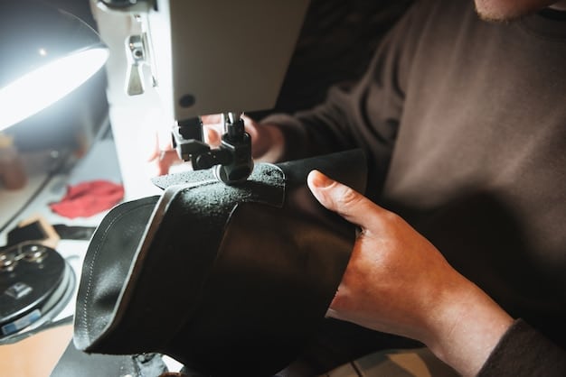 A craftsman carefully using a sewing machine to stitch together a piece of leather for automotive upholstery. The image captures the precision and skill required in the craft.