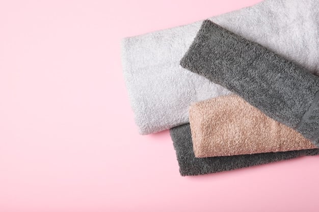 A high-quality microfiber towel set, neatly arranged with different colors and textures, next to a variety of detailing brushes and applicators. The background is a clean workbench with bottles of detailing products.