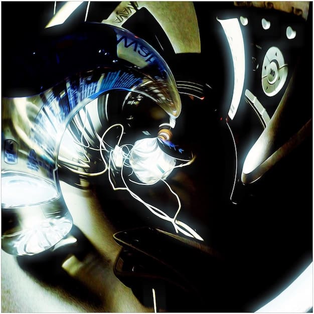 A detailed view of the 2025 Yamaha R1's front end, highlighting its aggressive headlights, aerodynamic fairings, and the Yamaha logo. The image emphasizes the bike's sporty and modern design.