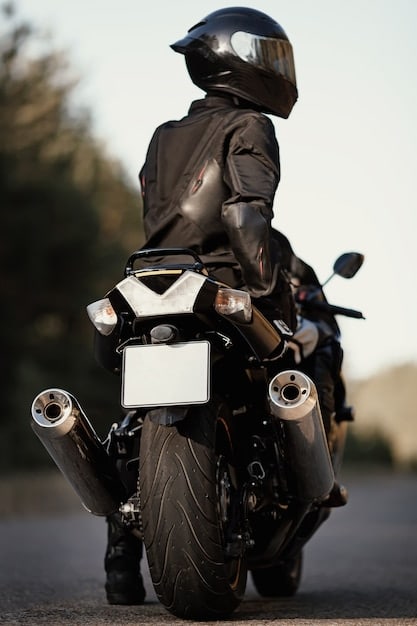 A rider leaning into a turn on a 2020 Suzuki SV650, showcasing the bike's agile handling and balanced suspension. The rider is wearing proper gear, including a helmet, jacket, and gloves.