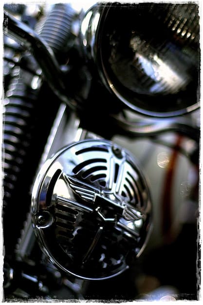 Close-up shot of the Indian Chief Dark Horse's Thunderstroke 116 engine, showcasing its blacked-out finish, intricate detailing, and prominent cylinder heads. The image highlights the engine's raw power and mechanical beauty, emphasizing its role as the heart of the motorcycle.